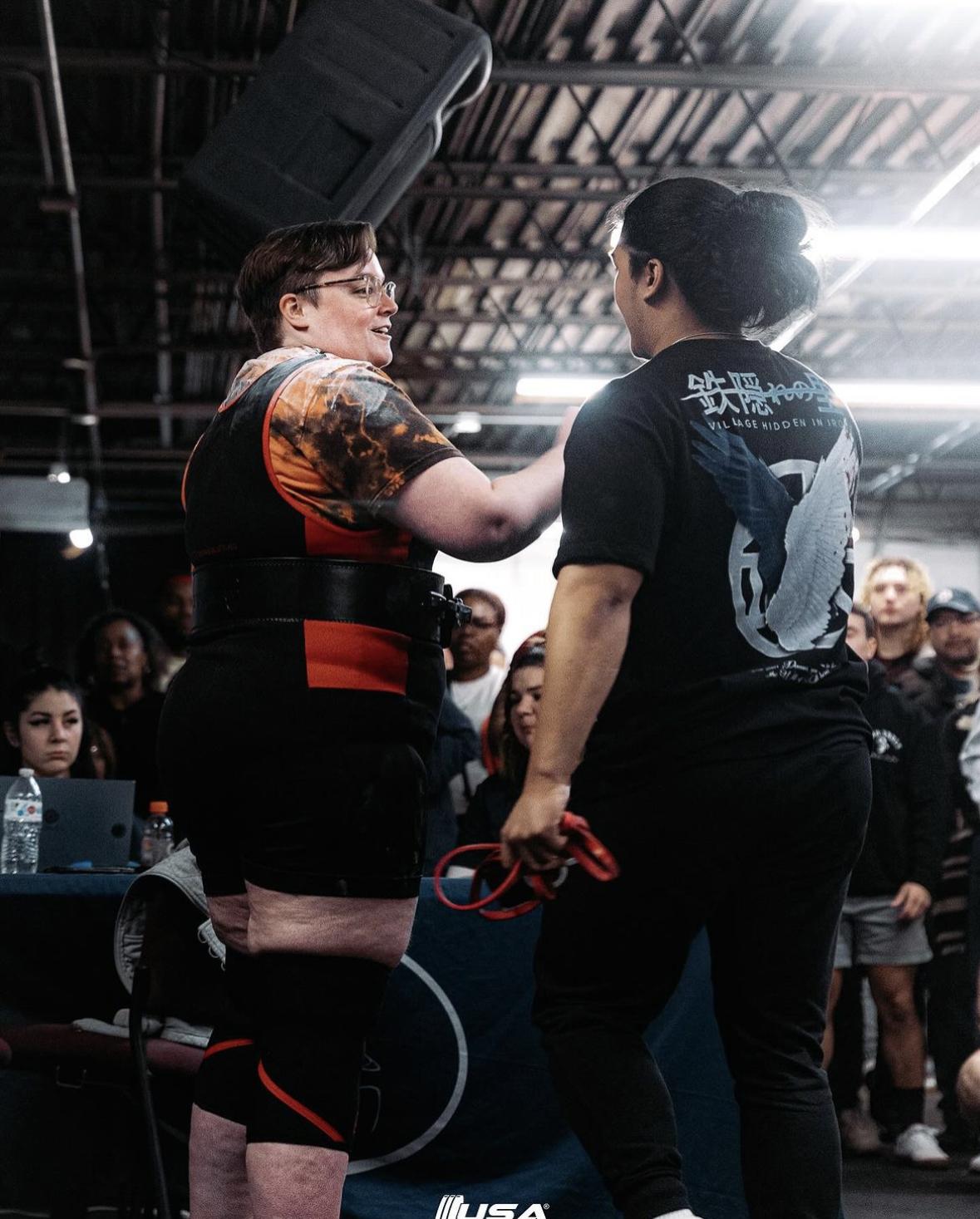 Clients embracing after a lift at a meet