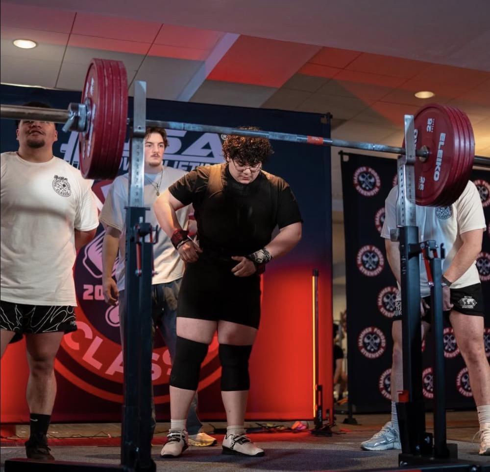 Client setting up for a squat at a meet